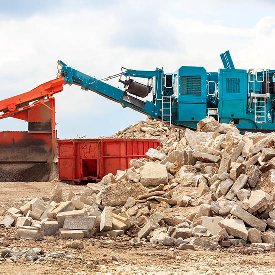 Concrete chrusing machines with a pile of recycled concrete